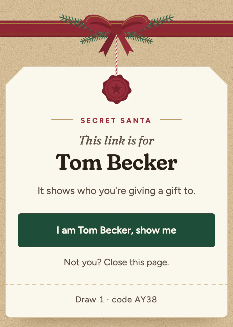 A gift tag hanging from a red ribbon, sealed with red wax. It reads Secret Santa, This link is for Tom Becker, It shows who you're giving a gift to, then a green button, I am Tom Becker, show me, and below it, Not you? Close this page. At the foot: Draw 1 and the draw's code.