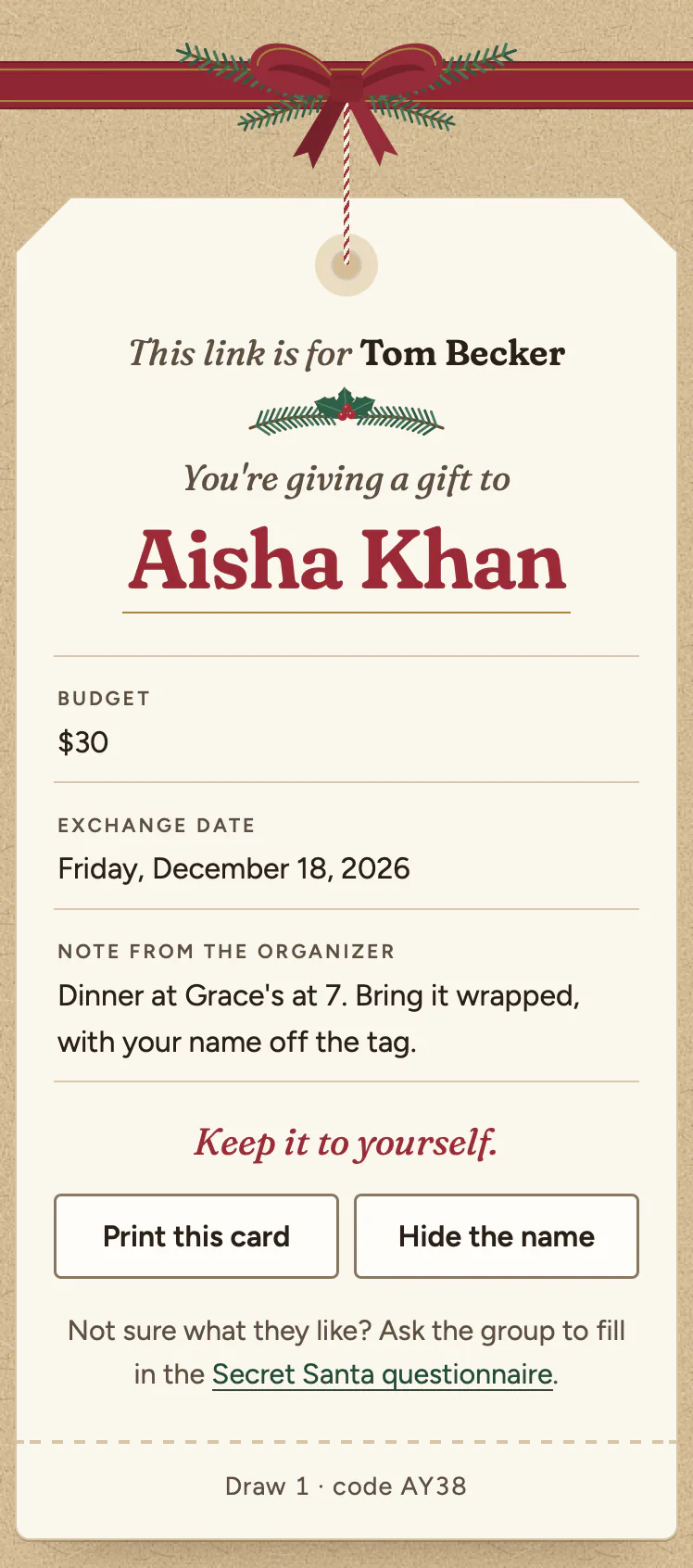 The same tag, turned over. This link is for Tom Becker. You're giving a gift to Aisha Khan, in large red letters. Budget: $30. Exchange date: Friday, December 18, 2026. Note from the organizer: Dinner at Grace's at 7. Bring it wrapped, with your name off the tag. Then Keep it to yourself, two buttons, Print this card and Hide the name, and a line suggesting the group fill in the Secret Santa questionnaire.
